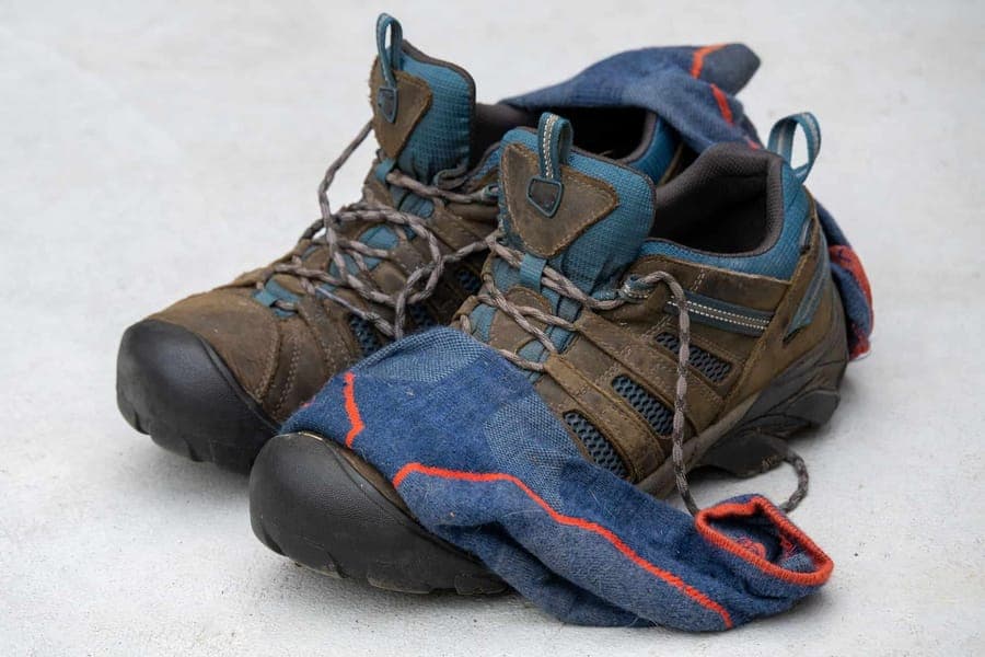 Hiking shoes with a pair of worn wool socks